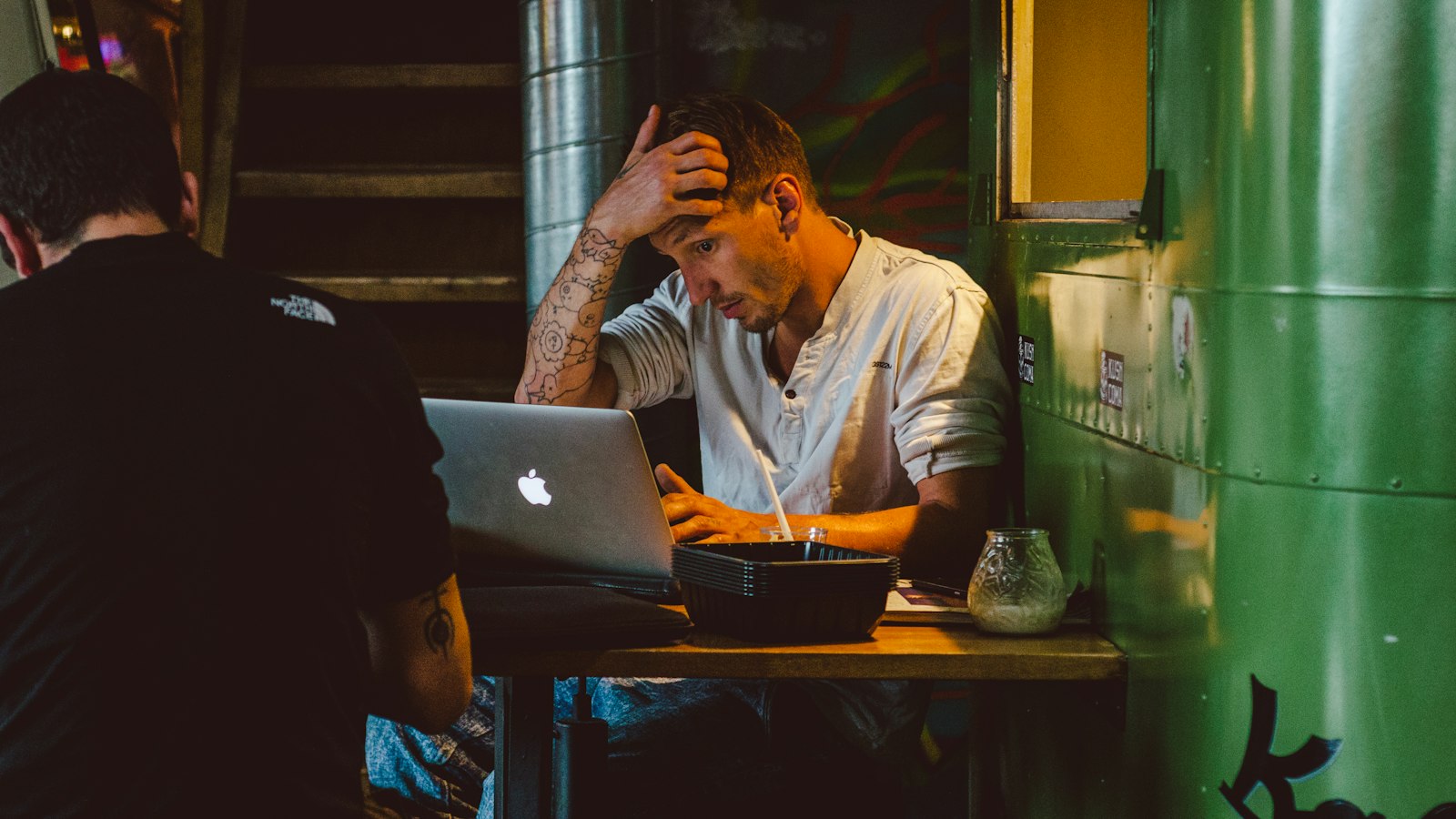 Mann sitzt nachdenklich vor dem Laptop